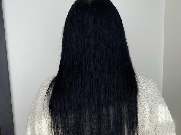 A client one year into wearing her hand-tied extensions
